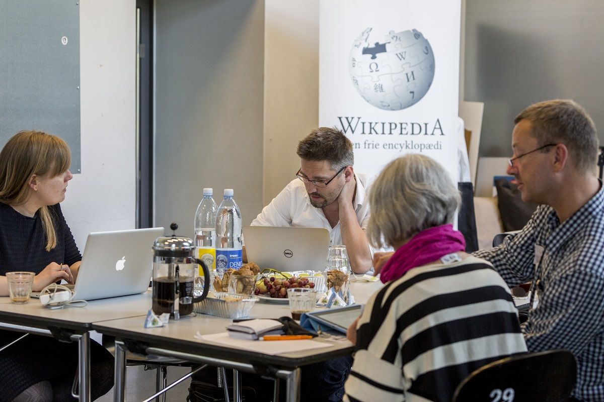 A wikipedia editathon - people sat working around a table